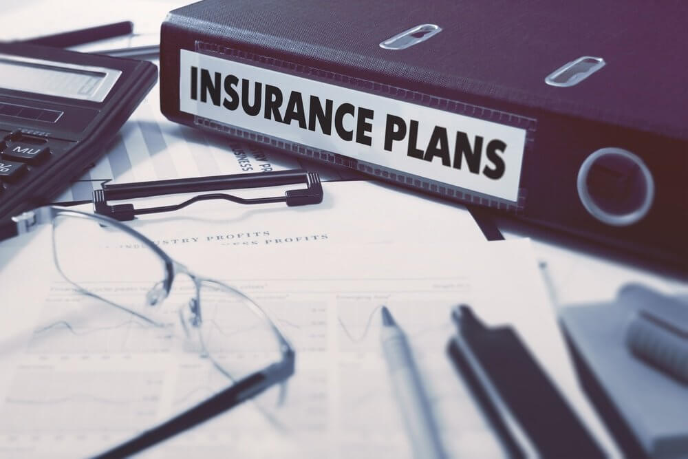 Insurance Plans - Ring Binder on Office Desktop with Office Supplies. Business Concept on Blurred Background. Toned Illustration..jpeg