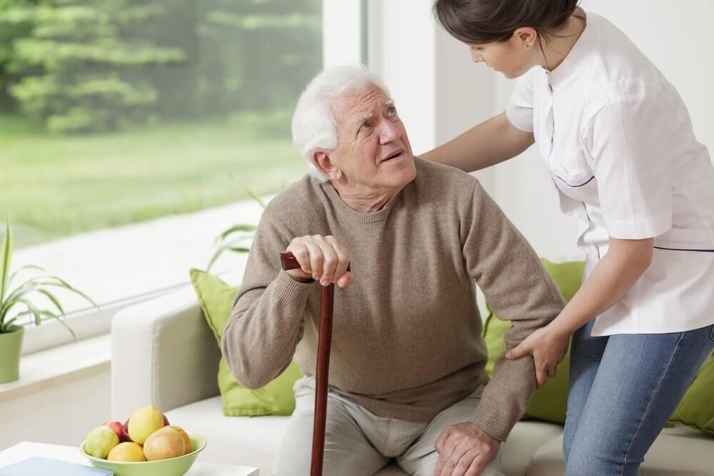 Young woman helping old man to stand up-1.jpeg