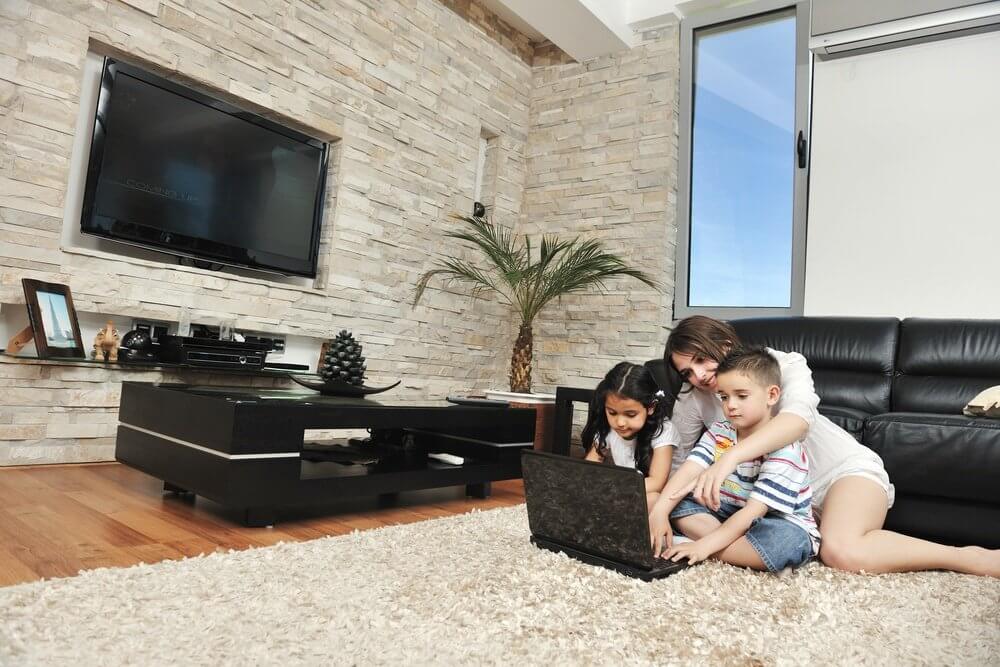 happy young family have fun and working on laptop at modern  home livingroom indoor.jpeg
